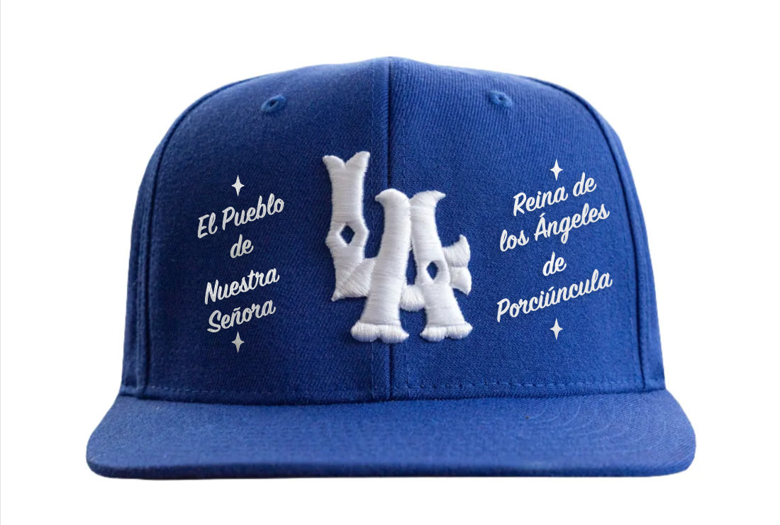 A blue baseball cap with white text and logo embroidery.